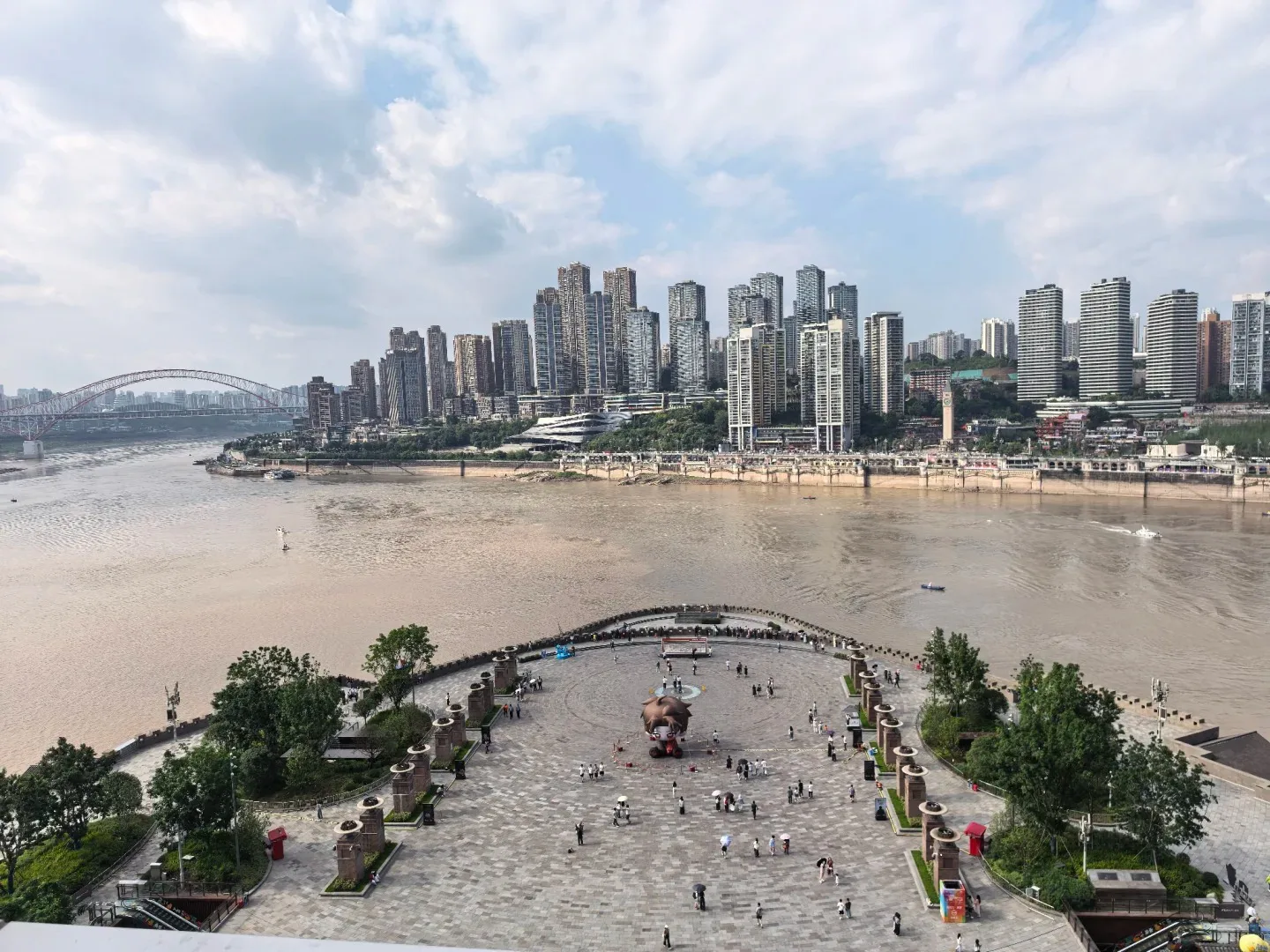 The Yangtze and Jialing rivers meeting beside Chongqing high-rises in daylight