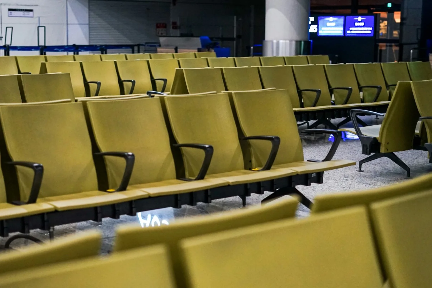 Rows of yellow seats inside a waiting area at Guangzhou Baiyun International Airport