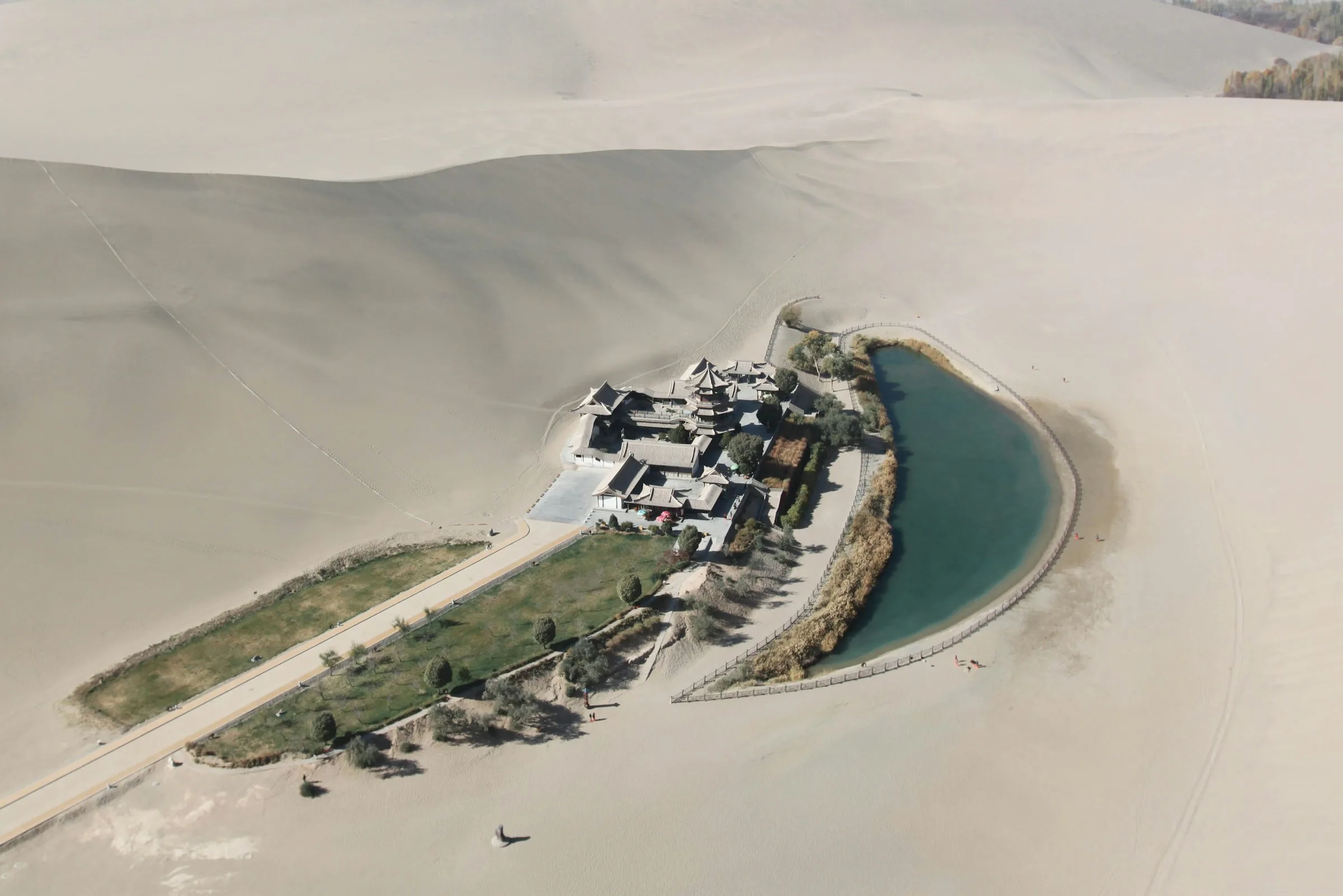 Aerial view of Crescent Spring surrounded by the dunes of Mingsha Mountain in Dunhuang