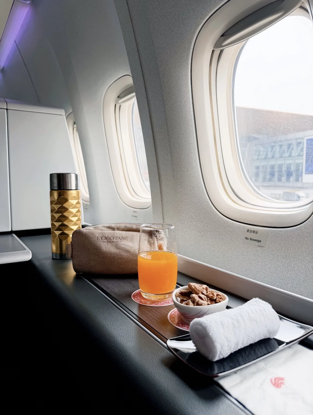 A window seat prepared for a long-haul flight to China