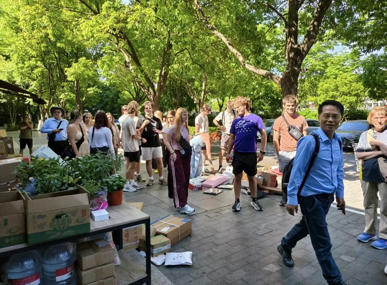 European travelers meeting a guide on a shaded street in China