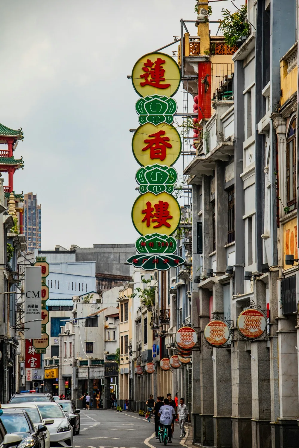 A narrow Guangzhou street lined with historic shop signs and Cantonese characters