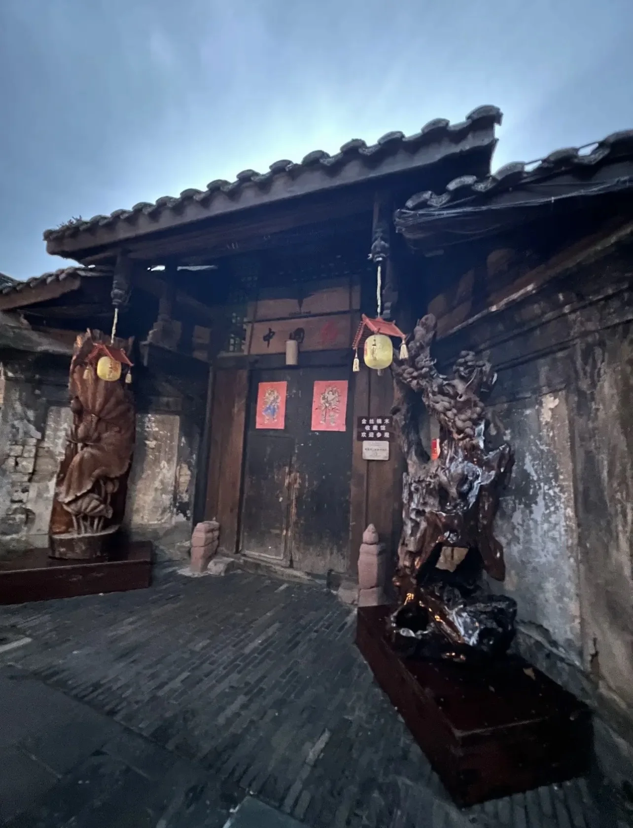 Historic grey-brick courtyard entrance with carved wood features in Chengdu Kuanzhai Alley