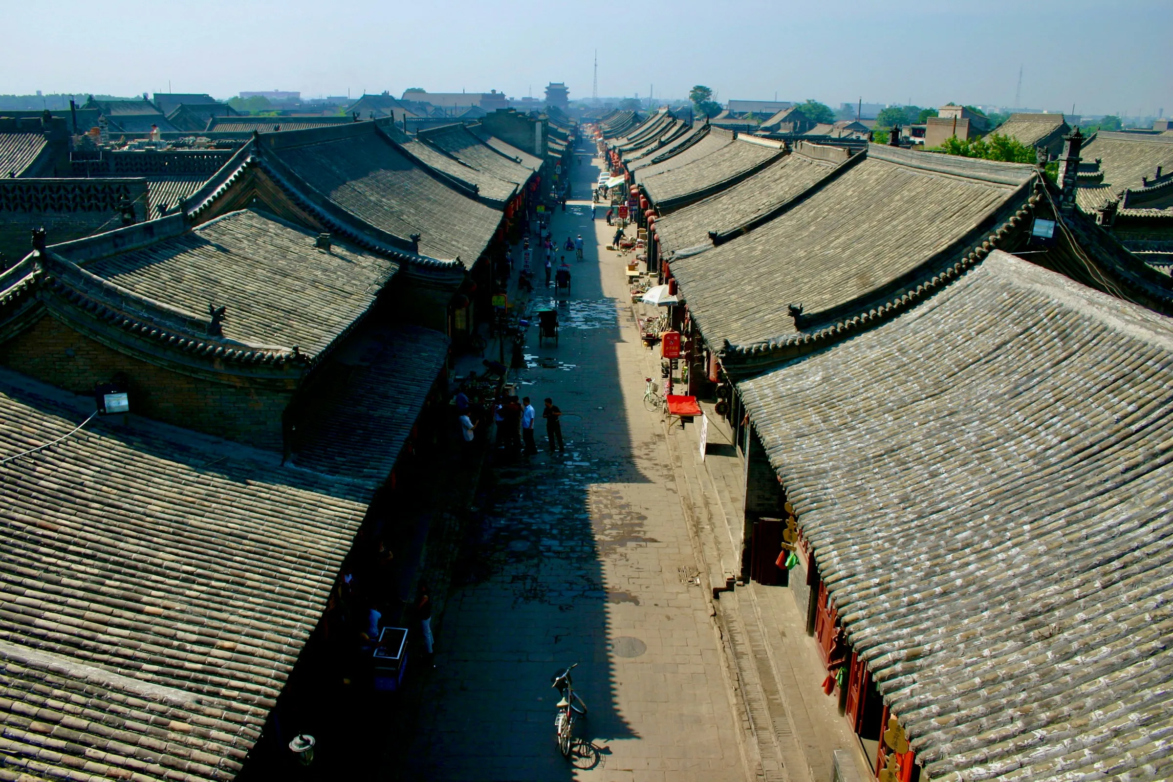 Elevated view across Pingyao's dense grey-tiled roofs, courtyards and straight historic street grid