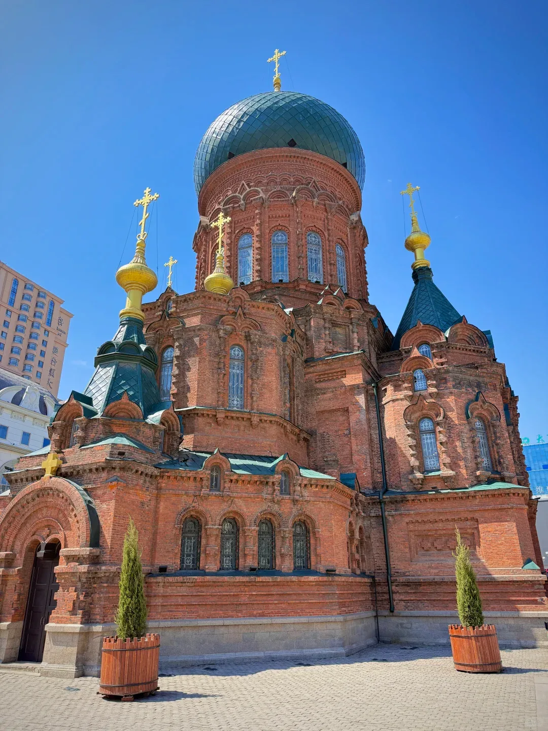 Red-brick Saint Sophia Cathedral beneath a clear blue sky in Harbin
