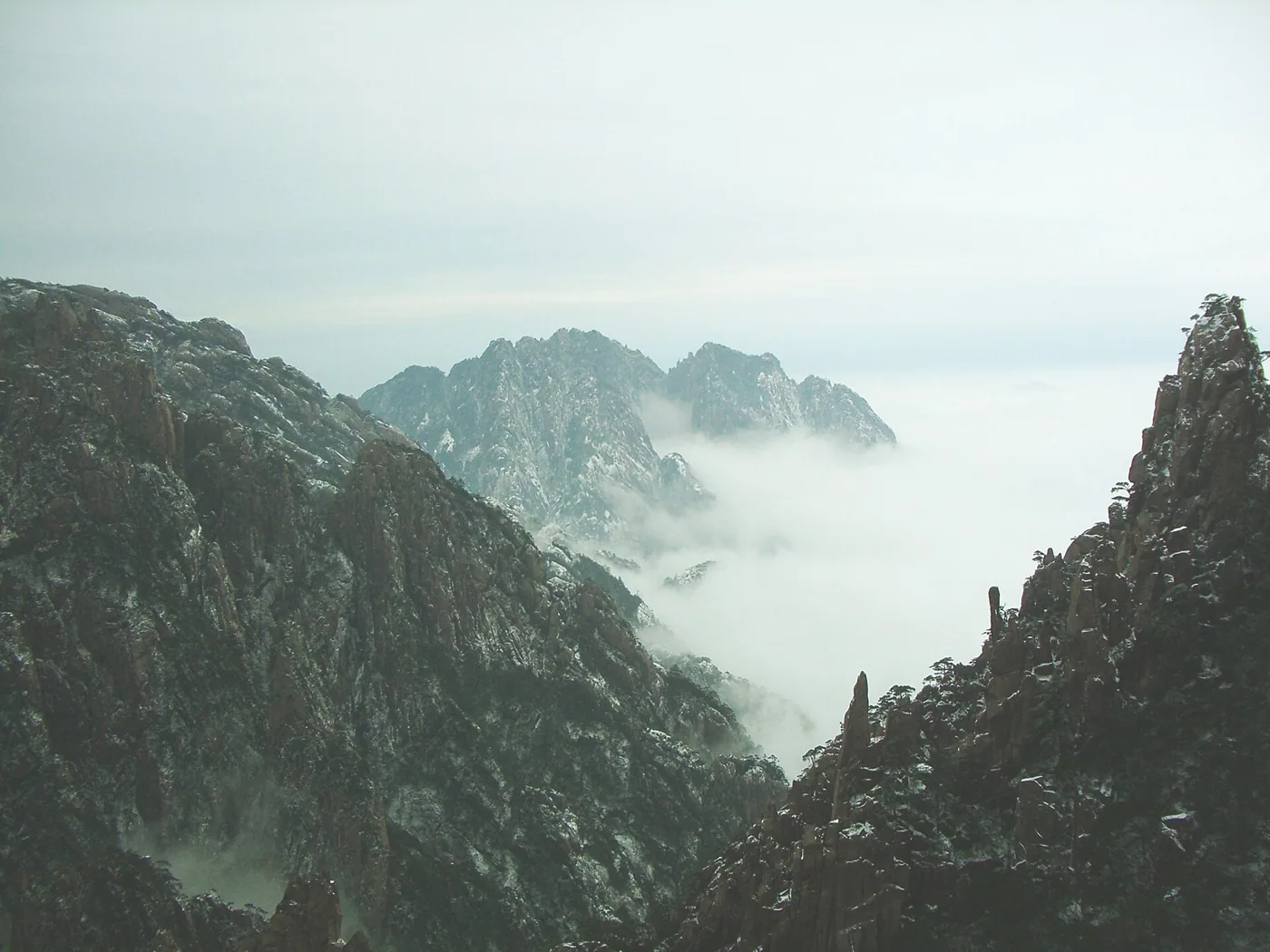 Rocky Huangshan peaks rising through a sea of cloud