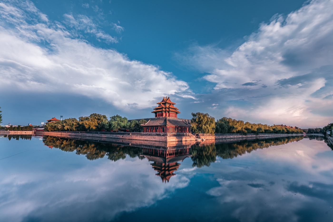 A corner tower of the Forbidden City reflected in the still moat at dusk, Beijing