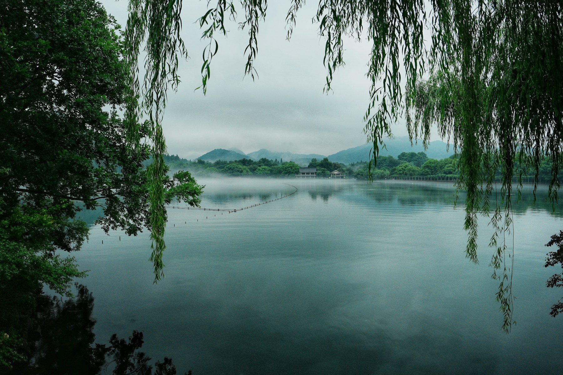 Misty water and green hills around West Lake in Hangzhou