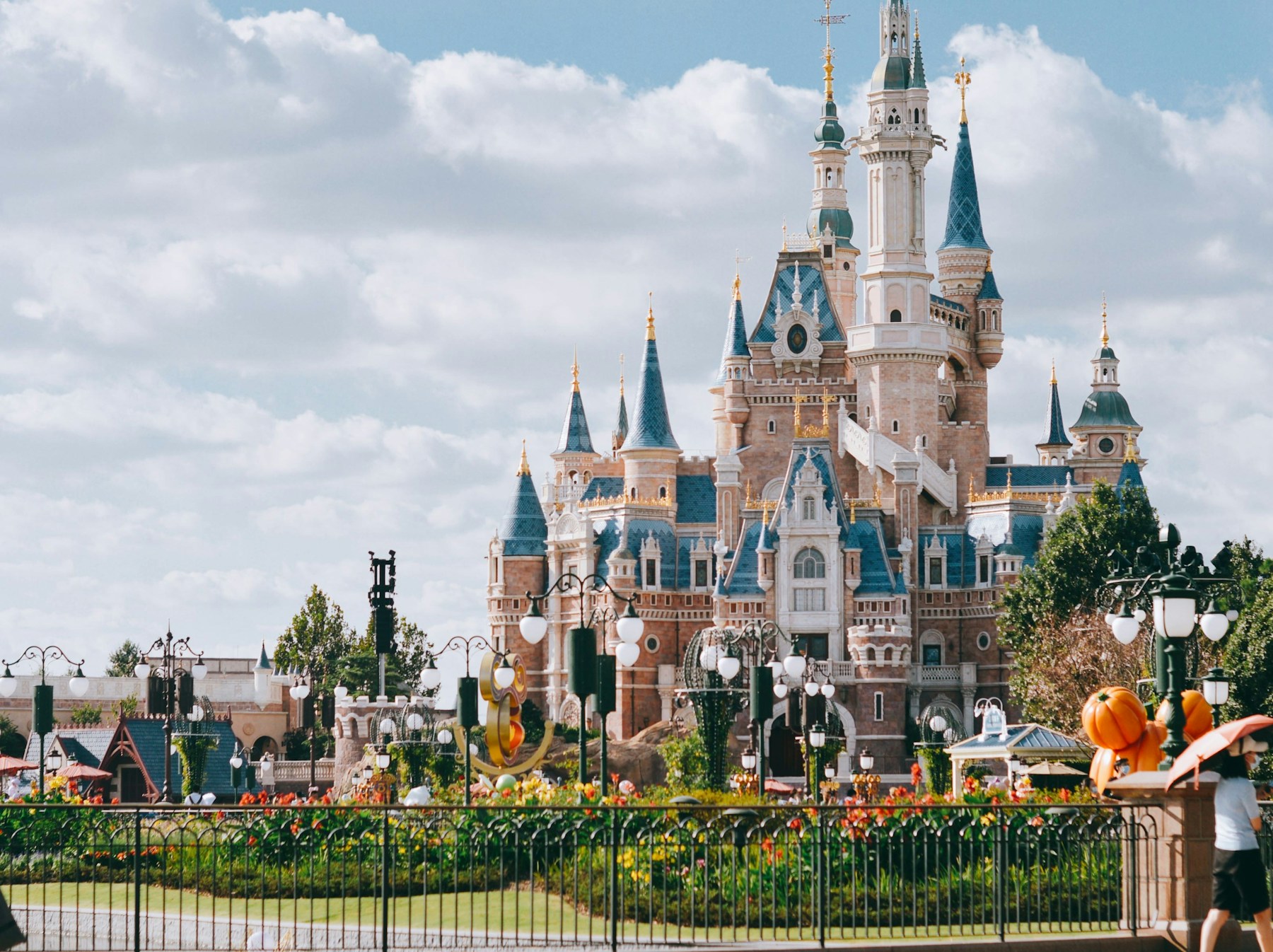 A large fairytale castle with turrets and towers under a bright sky