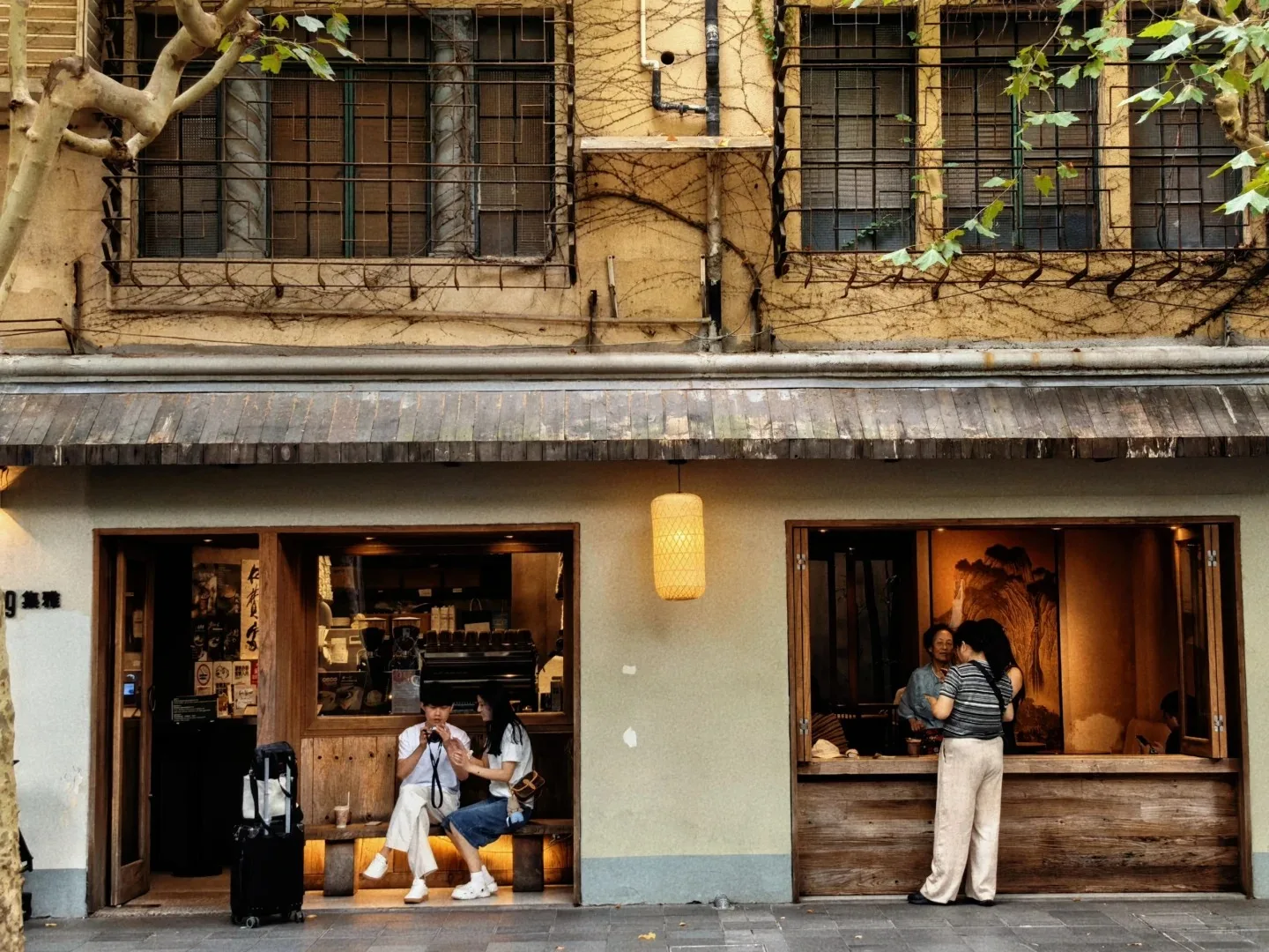 上海・旧フランス租界の古い住宅を改装した通り沿いのカフェと旅行者