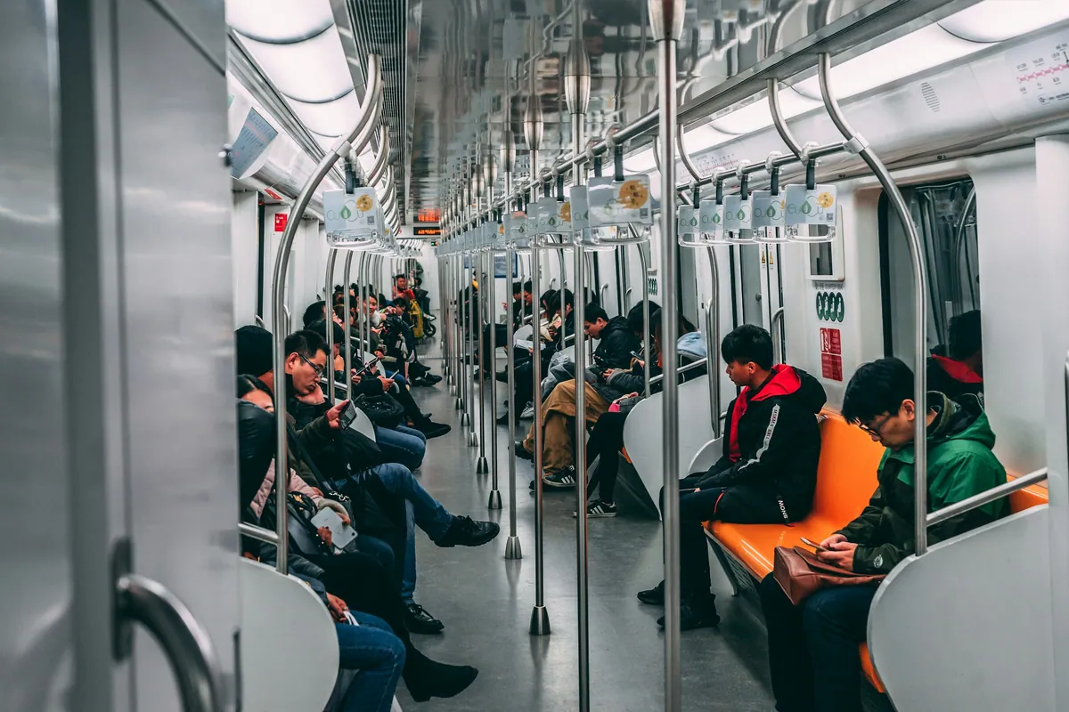 Passengers seated inside a modern metro train