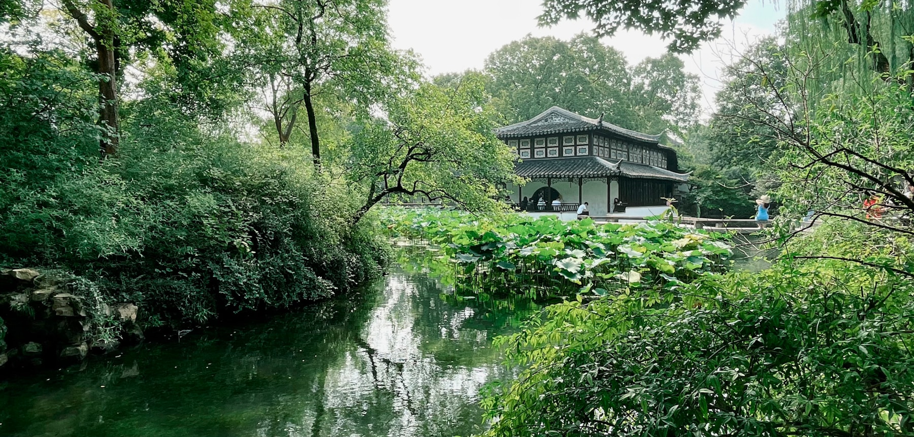 A lake and traditional waterside buildings in a Suzhou garden
