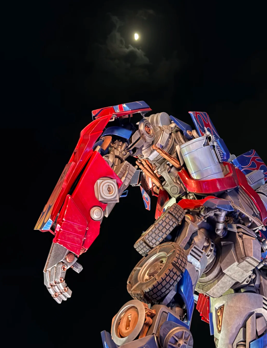 A Transformers robot statue lit at night in Universal Beijing Resort