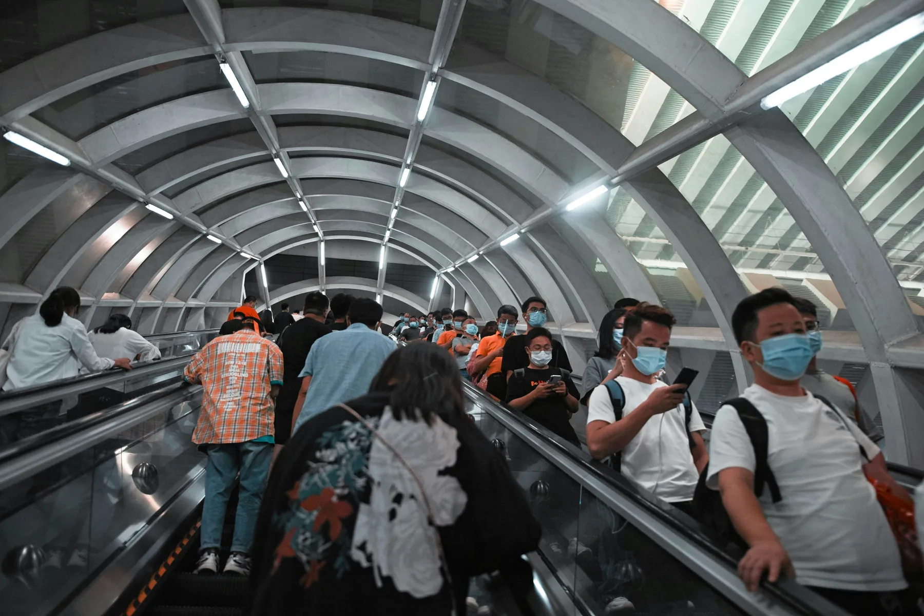 Passengers walking through a modern Shenzhen Metro station