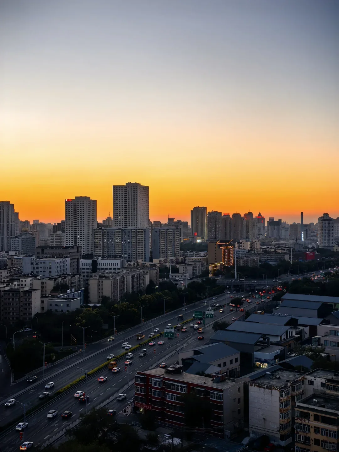 Urumqi city skyline and mountains seen from Red Hill at sunset