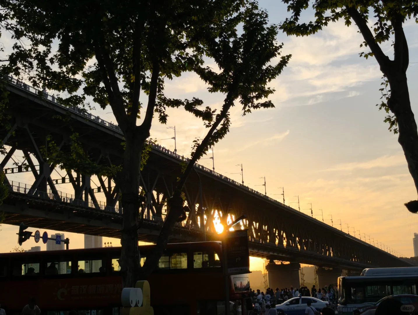 Wuhan Yangtze River Bridge silhouetted against a warm sunset