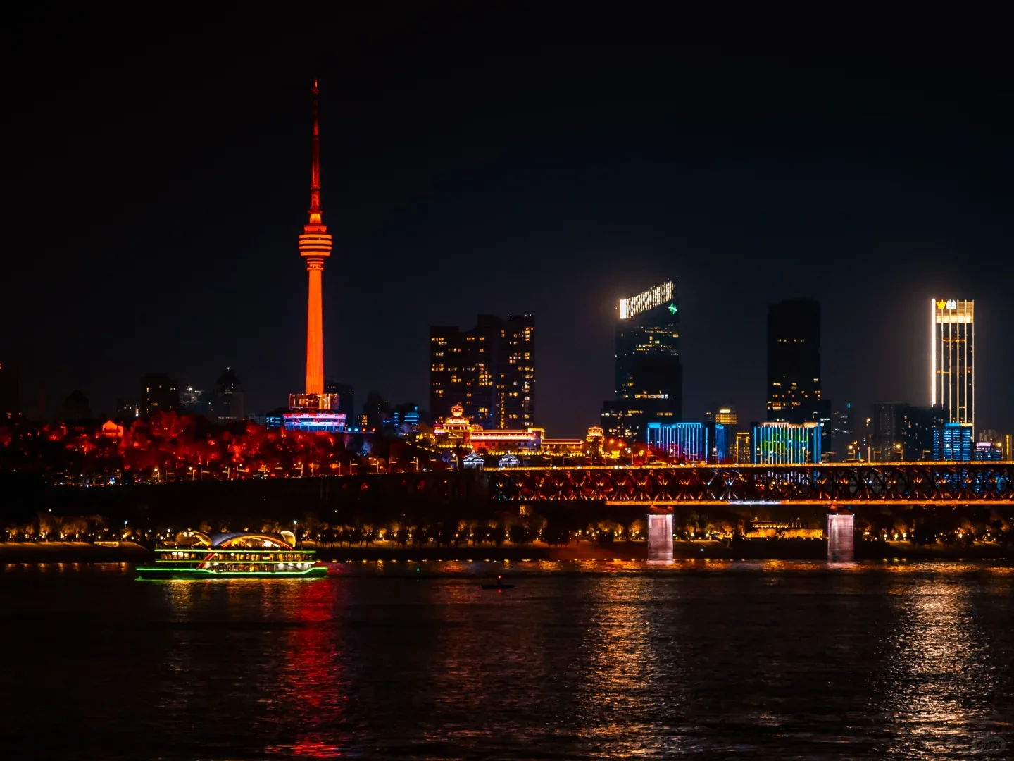 Illuminated Wuhan skyline reflected across the Yangtze River at night